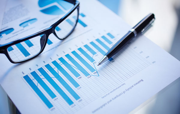 Glasses and pen sitting on business documents